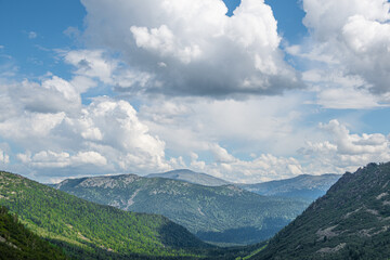 Wall Mural - Blue sky and clouds over the rocks, beautiful cloud landscape over mountain range