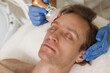 © mad_production - Mature man relaxing during rf-lifting facial procedure at dermatology clinic