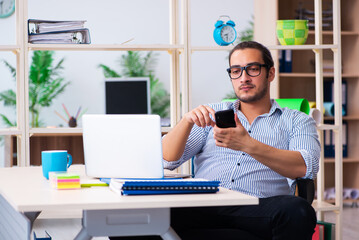 Young male employee working in the office