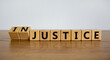 © Dzmitry - Justice instead of injustice. Turned cubes and changed the word 'injustice' to 'justice'. Beautiful wooden table, white background, copy space. Business and justice or injustice concept.