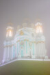 The ancient Baroque St. Andrew's Church rises above Andriyivskyy Uzviz and Vozdvyzhenka in a thick autumn fog. Mysterious and charming plot from the narrow streets of the ancient city of Kyiv, Ukraine