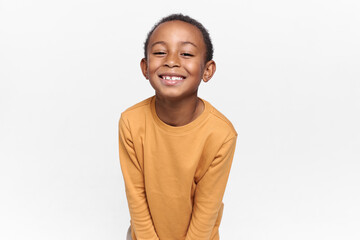 positive emotions, joy and happy childhood. adorable black boy posing against blank white copy space