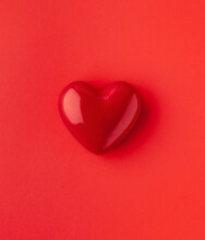 Valentine's Day Or Wedding Romantic Concept. Red Heart On Red Background. Top View, Copy Space.
