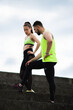 © Georgii - Sports young couple in sportswear having rest during workout outdoor on stairs