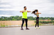 © Georgii - Sporty couple exercising before training. Athletic pair preparing for jogging outdoors. Sport active lifestyle
