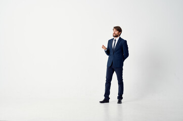 business man in a classic suit in full growth on a light background