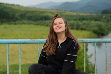 Cheerful plus size teenage girl wearing walking near mountains. smiling, happy, positive emotion, happiness enjoyed alternative lifestyle. Real unfiltered people concept