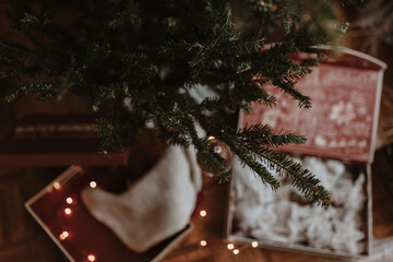 Christmas tree decorating. Holiday time. Lights, ornaments, vintage retro decor. Green fur tree. Merry Christmas, Happy New Year. Authentic tree ornaments. Holiday is over. Pack stuff to the boxes.