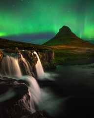 beautiful aurora dancing over kirkjufell mountain in iceland, image noise due high iso