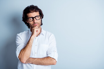 Photo portrait of thoughtful pensive man touching face chin with finger looking at blank space isolated on clear white colored background