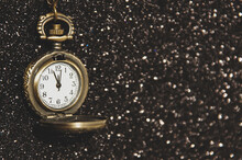 The Antique Clock Shows Almost Midnight Against A Sparkling Black Background. New Year Concept. Place For Your Text.
