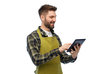 Wall Mural - gardening, farming and technology concept - happy smiling male gardener or farmer in apron and rubber boots with tablet pc computer over white background