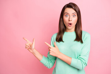 Poster - Photo of cute shocked girl indicate forefinger empty space wear teal pullover isolated pink color background