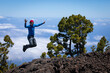 man on the top of the hill above clouds with view on canary islands