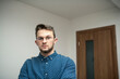 © FarukPhotography - a portrait of a young caucasian businessman wearing glasses standing and posing for a picture. white background.