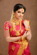 Beautiful Indian young Hindu Bride against brown background in studio shot