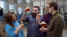 Young Hipster People Tasting Fresh Beer In Modern Brewery