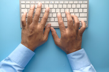 Close up of man hand typing on keyboard 