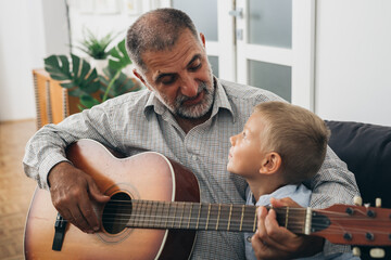 Wall Mural - grandfather and his grandson having fun together at home