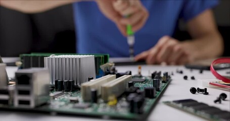 electronics repair and maintenance service. technician working with computer parts in office. slider shot