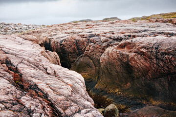 Sticker - Red rocks on coast of Barents Sea near Teriberka. Rugged northern landscape. Kola Peninsula, Murmansk Oblast, Russia