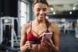 © Drobot Dean - Woman fitness coach using mobile phone in gym