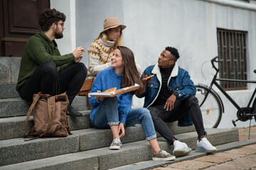 Wall Mural - Group of young people outdoors in town, eating pizza. Coronavirus concept.