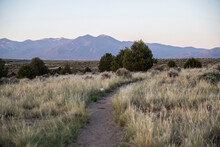Hiking Path Leading Towards The Desert Mountains In Taos New Mexico