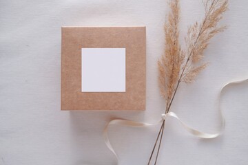 Wedding favor box and sticker mockup, blank square tag, card or sticker on gift box for design presentation, top view. 