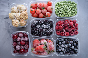 Wall Mural - Frozen berries in boxes top view on gray background