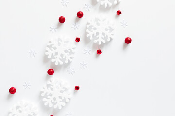 Wall Mural - christmas winter composition. white snowflakes, xmas red decorations on white background. christmas,