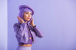 © LIGHTFIELD STUDIOS - young woman dressed in doll style in beret posing on violet colorful background