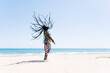 © VISTA by Westend61 - Rastafari man tossing his dreadlocks on the beach