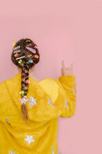 Teenage Girl With Various Hair Pins In Her Braid,  Making Horn Sign, Rear View