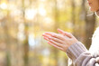 Woman rubbing and heatting hands in a cold autumn