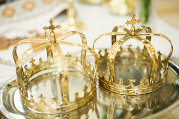 Golden crowns lying on the table in church