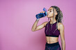 © oneinchpunch - Beautiful girl doing exercises and sport. Posing on a pink colored background