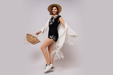 Wall Mural - Full lenght studio photo of glad woman with short hairstyle in stylish boho summer outfit. straw hat and bag.