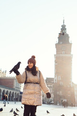 Canvas Print - Young woman and pigeons in Market Square, Krakow, Poland