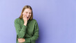 © Asier - Young blonde woman isolated on purple background laughs happily and has fun keeping hands on stomach.