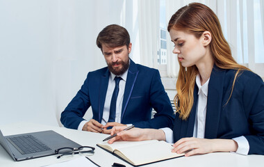 Employees in the office with laptop puzzled look documents emotions monitor keyboard