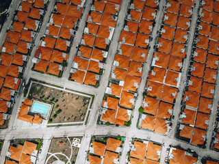 Aerial view from a drone lined up roofs of houses red-tiled. Beautiful landscape