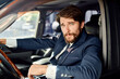 © SHOTPRIME STUDIO - handsome man in suit driving a car trip talking on the phone finance