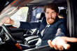 © SHOTPRIME STUDIO - aggressive business man looking out of the car window and gesturing with his hands