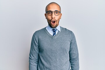 Wall Mural - Hispanic adult man wearing glasses and business style afraid and shocked with surprise expression, fear and excited face.