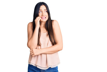 Sticker - Young beautiful caucasian woman wearing casual clothes looking stressed and nervous with hands on mouth biting nails. anxiety problem.