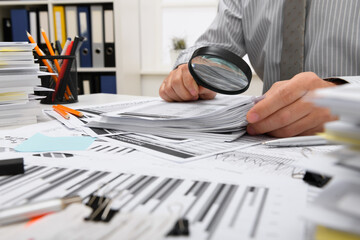 Wall Mural - business concept - businessman working with reports in office, table and workspace close view, analyzing financial data, writes and counts