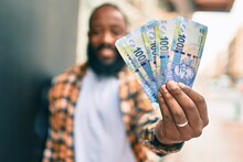 Handsome Modern African American Man With Beard Smiling Positive Standing At The Street Showing 100 South African Rands Banknotes