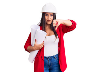 Sticker - Young beautiful brunette woman wearing hardhat holding architect blueprint with angry face, negative sign showing dislike with thumbs down, rejection concept