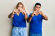 © Krakenimages.com - Young interracial couple wearing casual clothes rejection expression crossing fingers doing negative sign